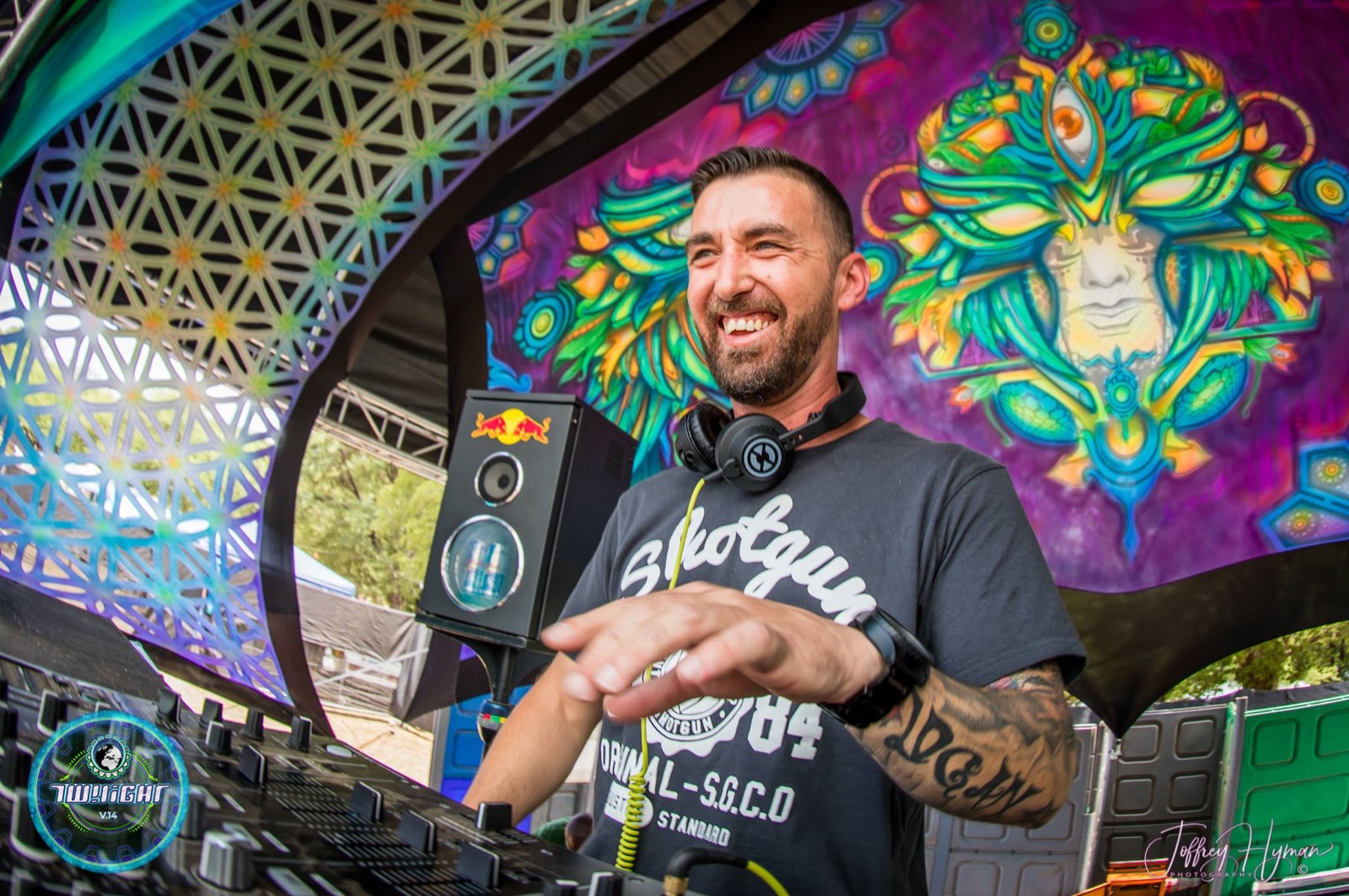 Dan Scot smiling while performing at a festival