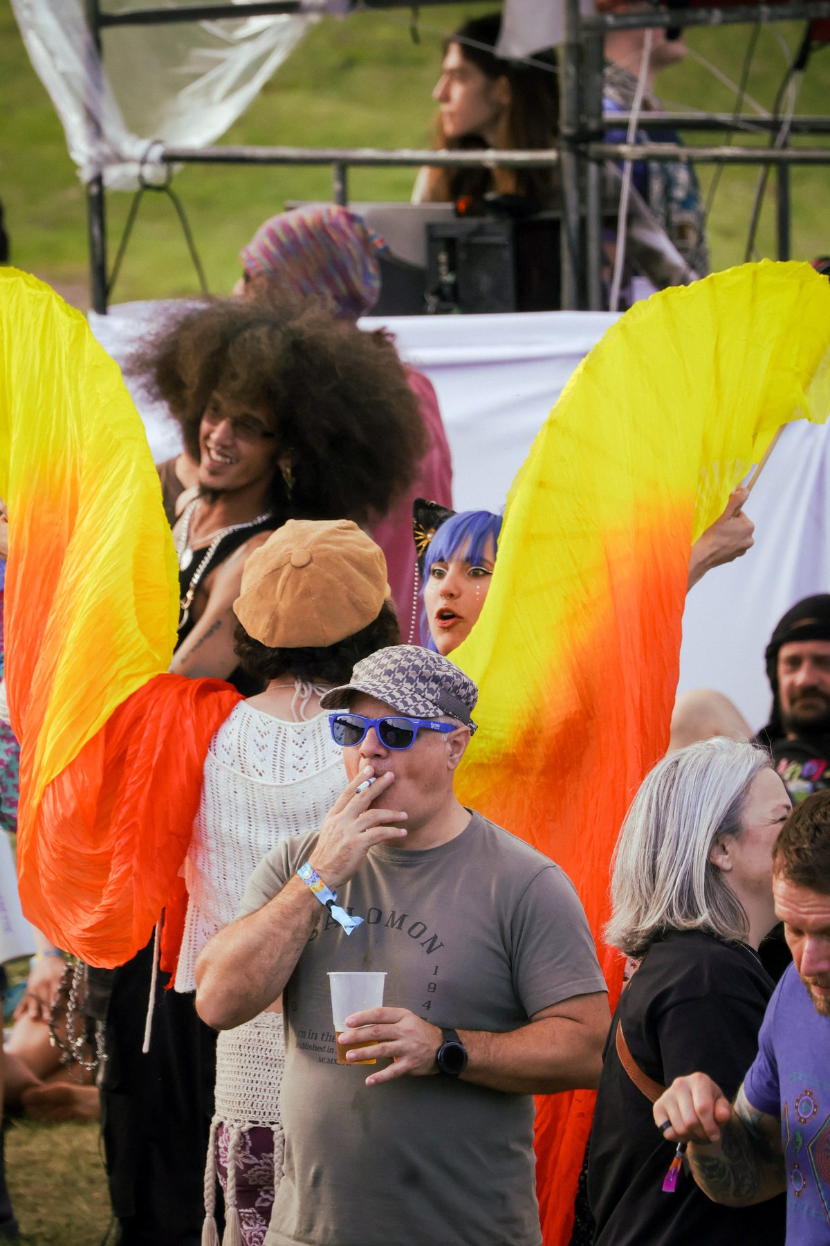 A dancer with fire-coloured fan veils at Earthdance Cape Town 2026