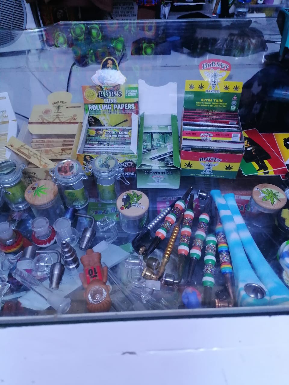 A display case of rolling papers, grinders and colourful smoking pipes