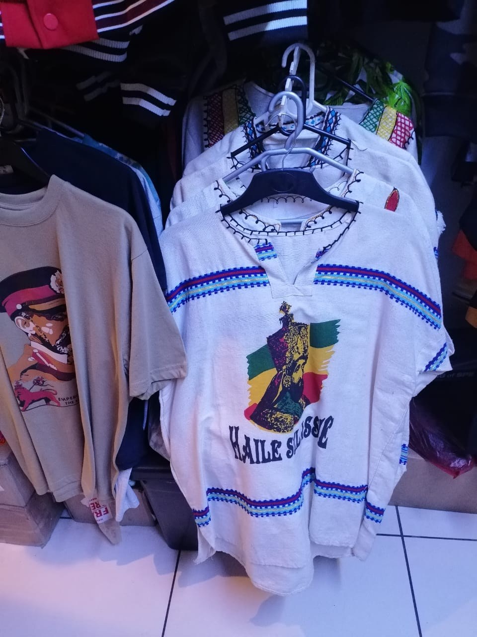 A white embroidered tunic printed with an image of Haile Selassie