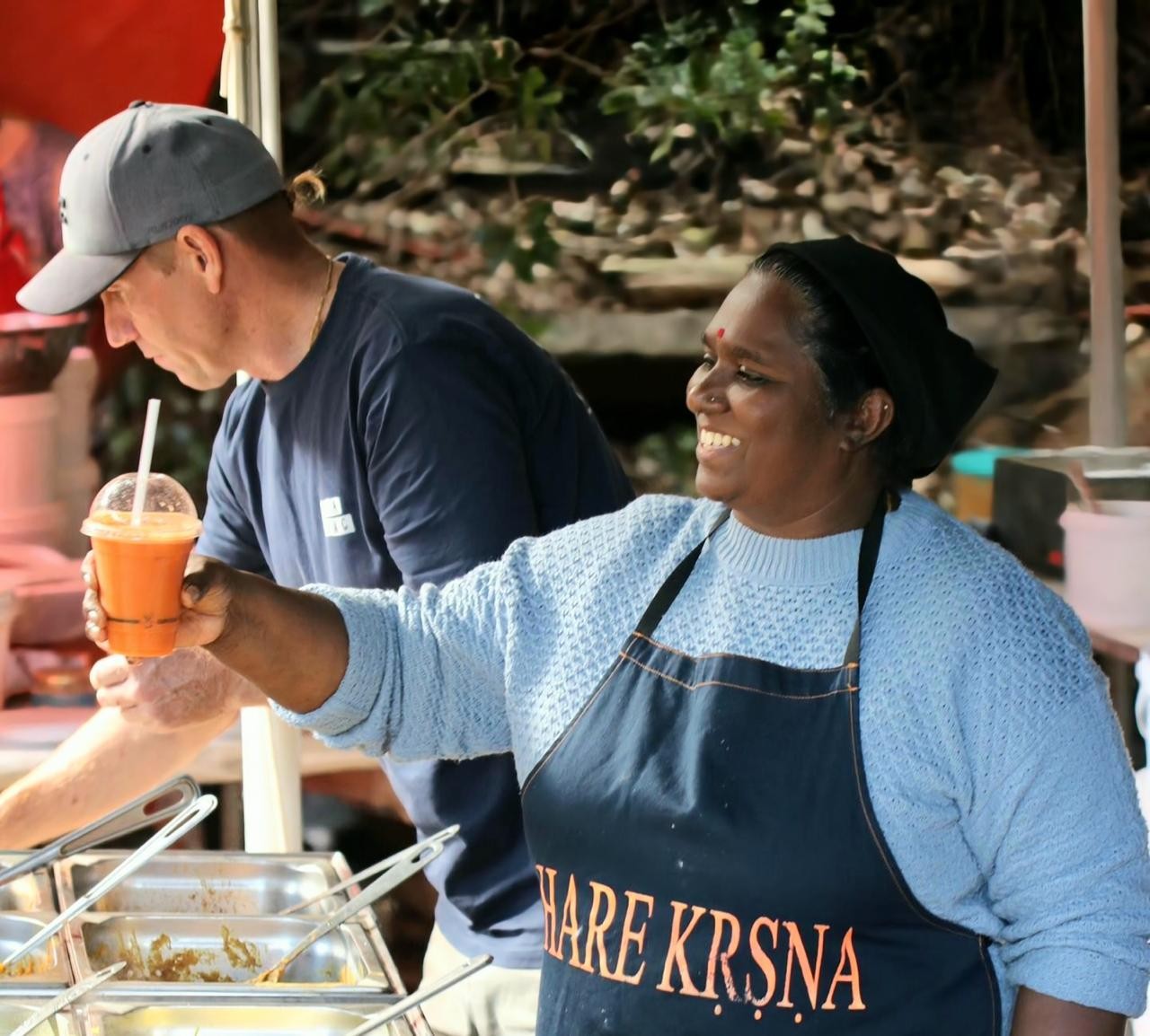 Rupa and Shyama serving a fresh juice at the Atma stall