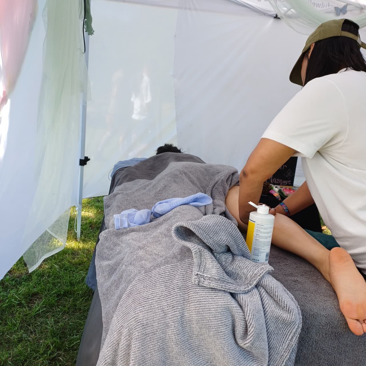 A foot and calf massage in progress inside the tent