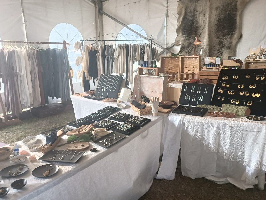 Handmade rings, earrings and necklaces laid out on the Earth Stories stall table
