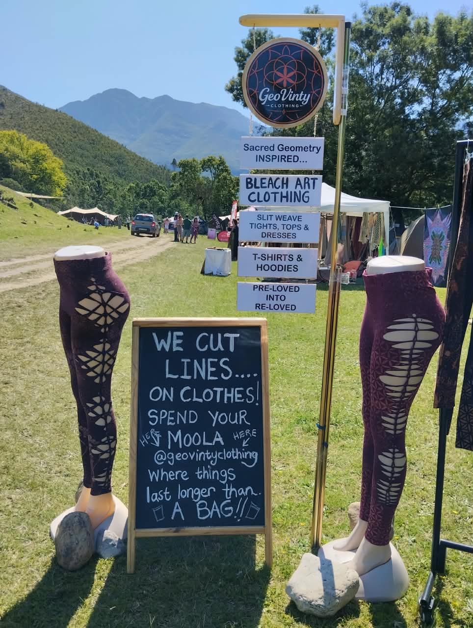 A chalkboard reading We cut lines on clothes beside mannequins in laser-cut leggings