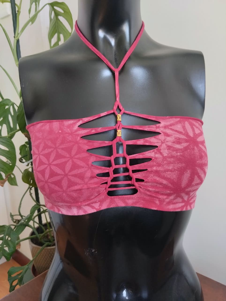 Maroon halter top with a laser-cut flower-of-life lattice at the chest