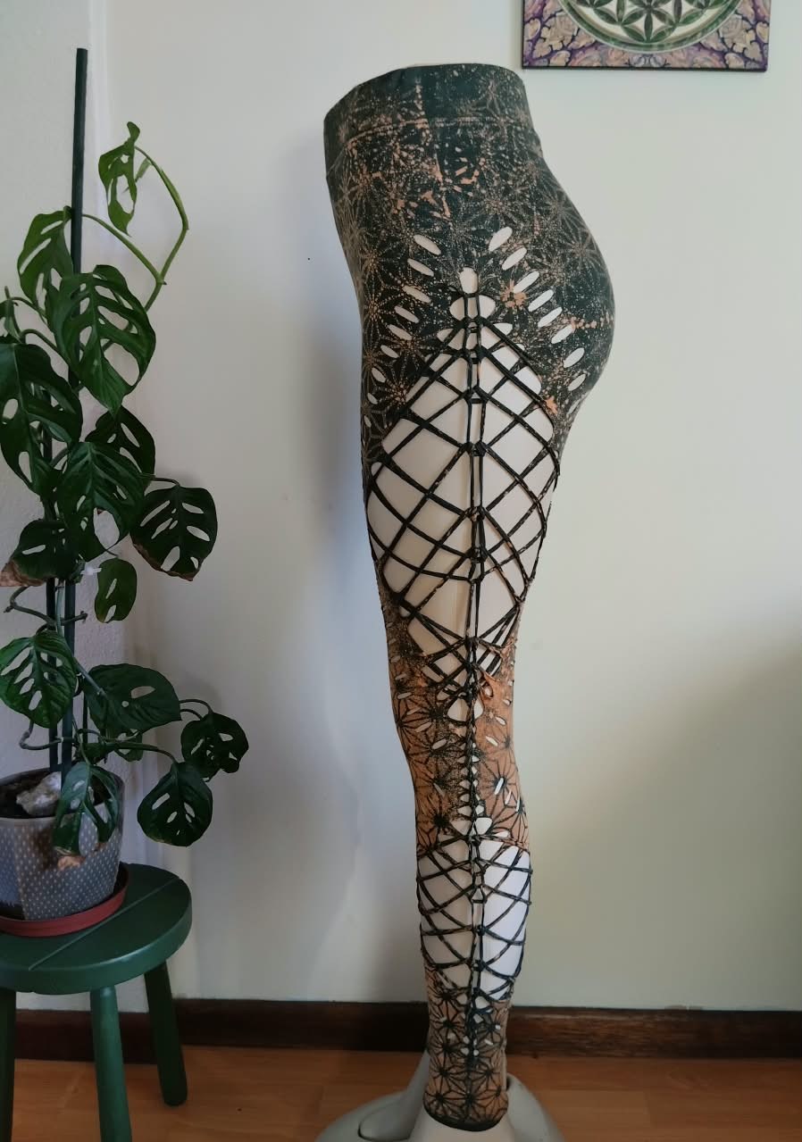 Green sacred-geometry leggings with laser-cut side panels, side view