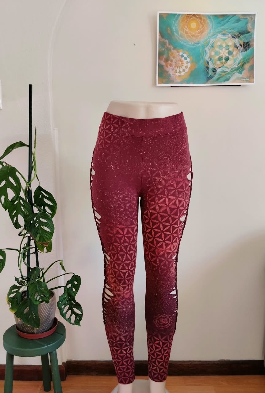 Burgundy sacred-geometry leggings with laser-cut side panels, front view