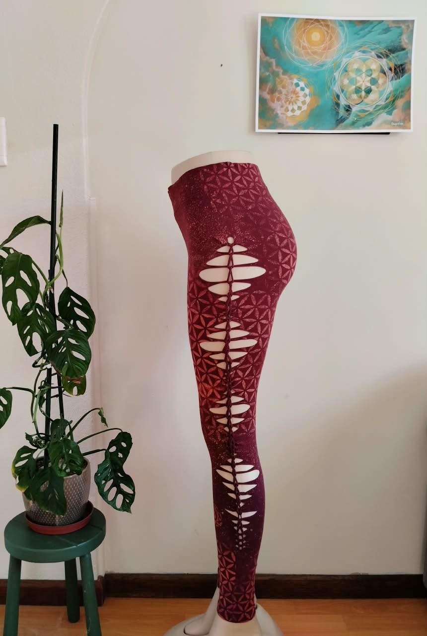 Burgundy sacred-geometry leggings with laser-cut side panels, side view