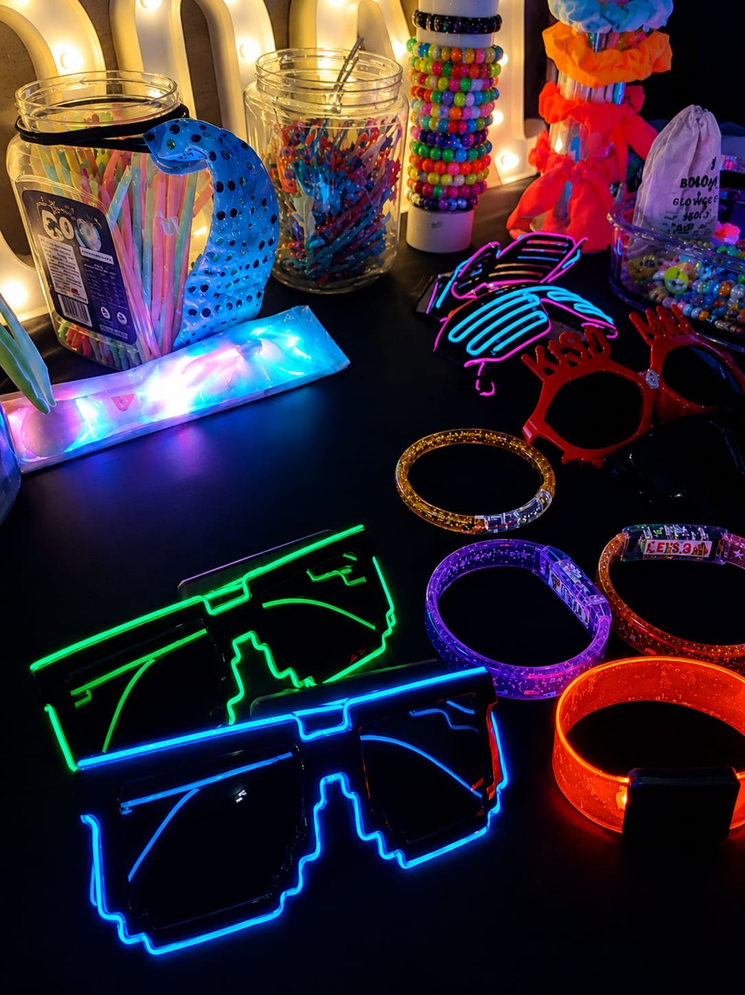 Glow bracelets and LED glasses laid out on the table