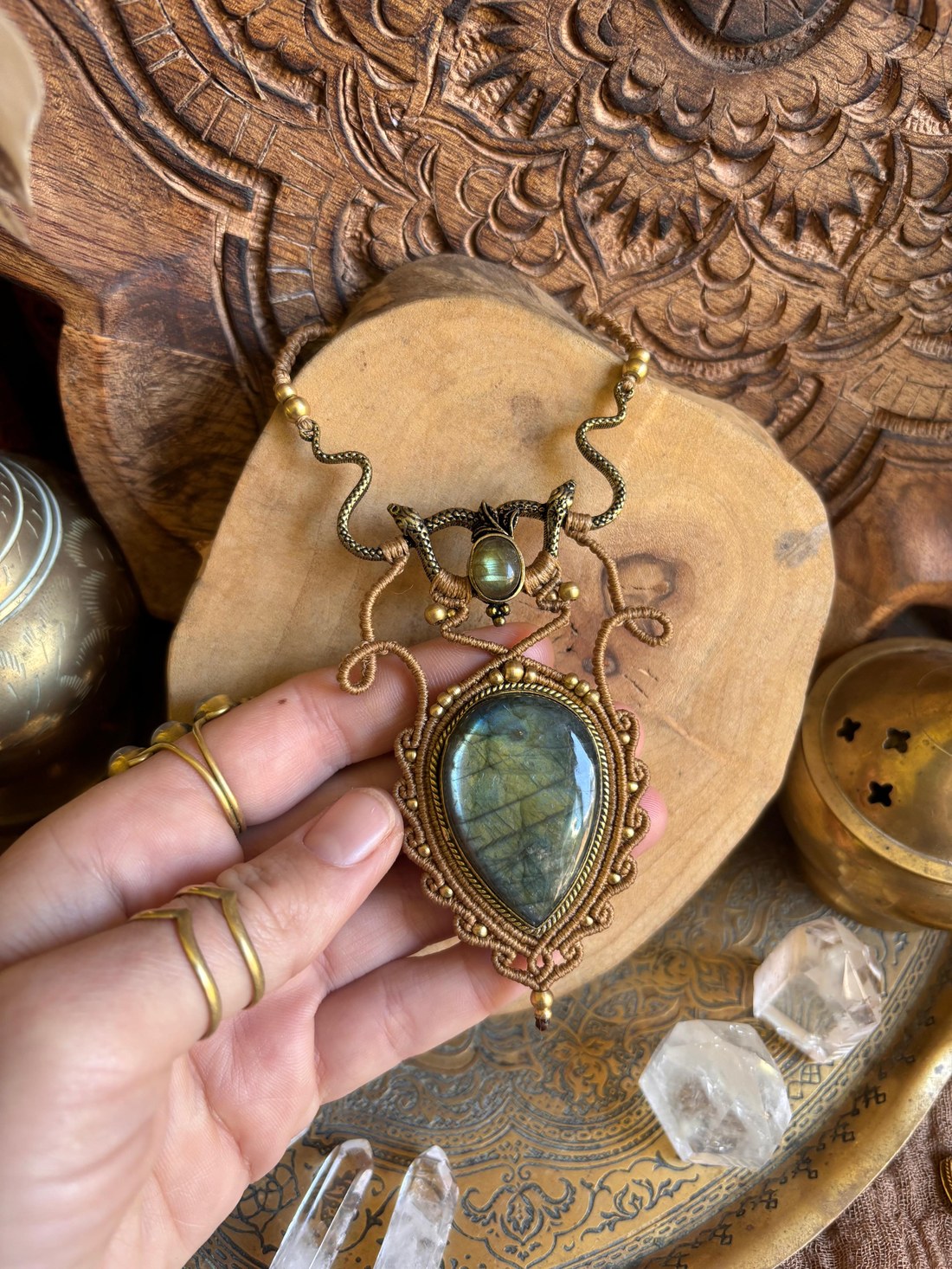 A snake-motif macramé necklace with a labradorite teardrop pendant