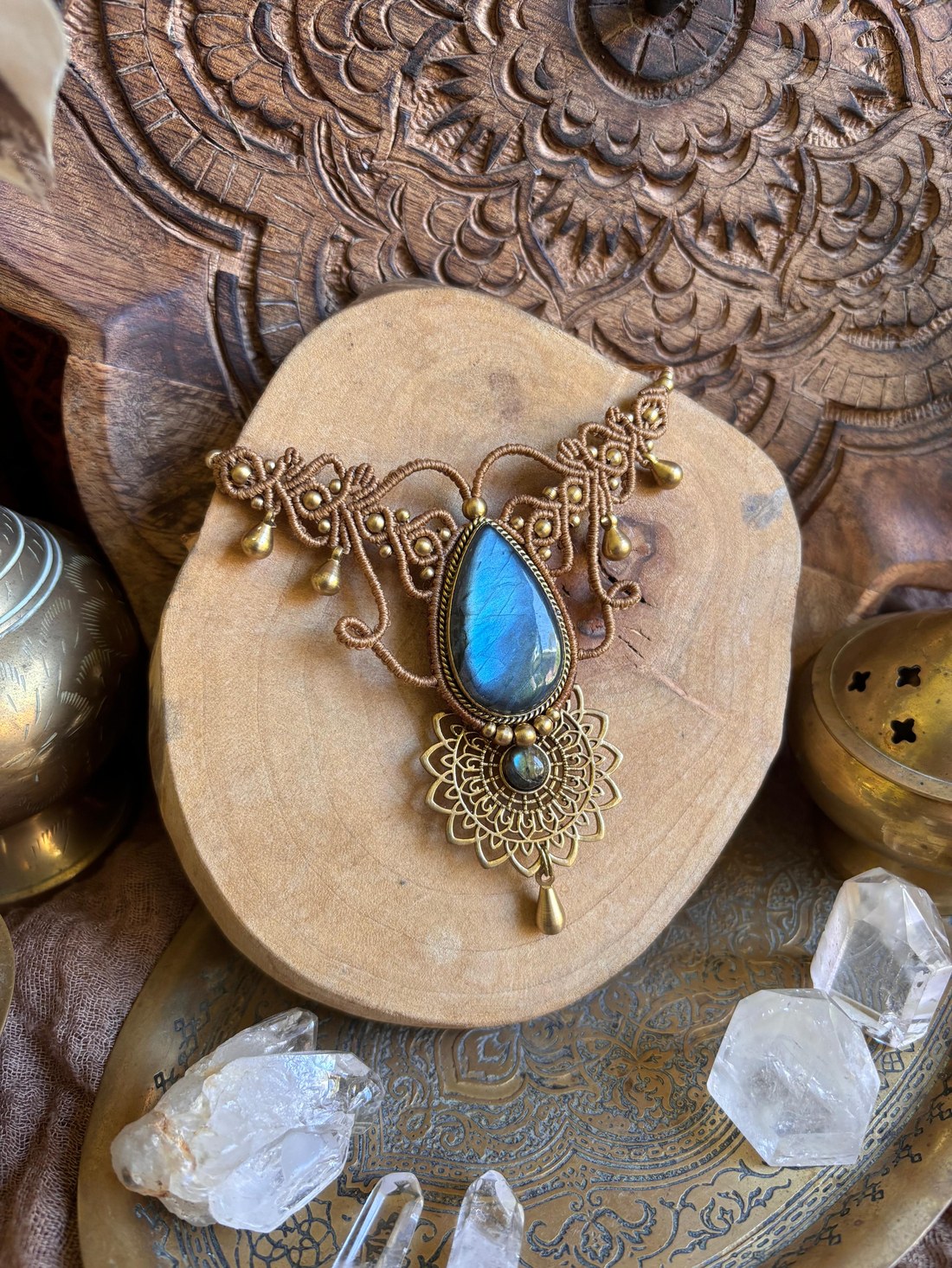 A macramé necklace with an oval labradorite stone and beaded drops