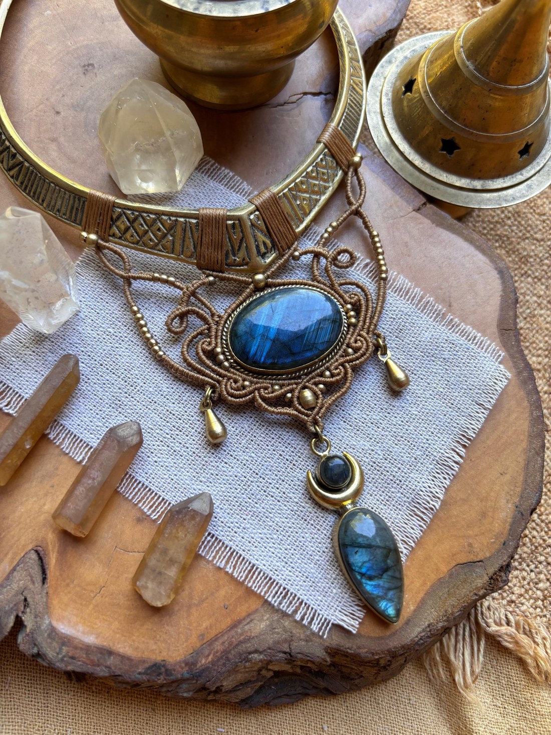 A brass choker with a labradorite pendant and crescent moon charm